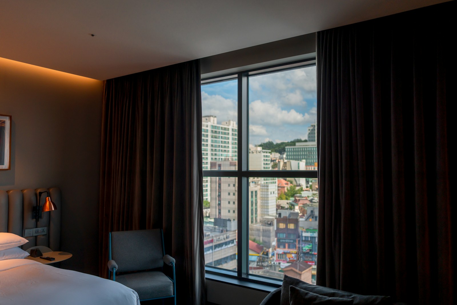 A modern hotel room with a city view through the window